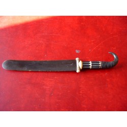 Antique letter opener with claw-shaped handle.